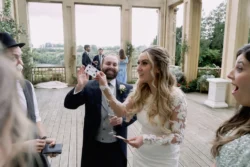 A bride and groom are playing a game of cards at Orchardleigh House, with their memorable moments captured by a talented wedding photographer.