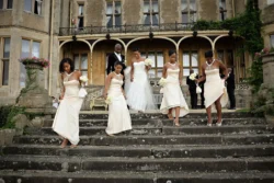 www.thefxworks.co.uk A bride and her bridesmaids descending the steps of an elegant building for an Orchardleigh House Wedding.