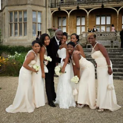 www.thefxworks.co.uk Groom posing with bridesmaids outside Orchardleigh House.