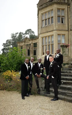www.thefxworks.co.uk A group of men in formal attire posing on the steps of an elegant Orchardleigh House.