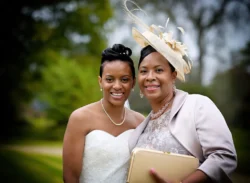 www.thefxworks.co.uk Bride smiling with a well-dressed guest outdoors at an Orchardleigh House wedding event.