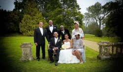 www.thefxworks.co.uk A family dressed in formal attire posing for a photograph at an Orchardleigh House wedding ceremony.