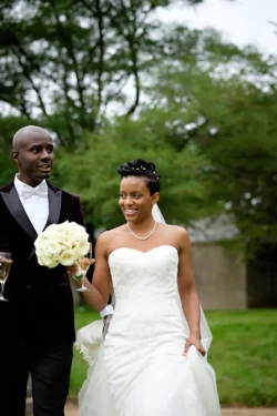 www.thefxworks.co.uk Bride and groom walking together with smiles, holding hands and champagne glasses, amidst an outdoor setting at Orchardleigh House.