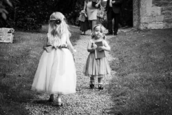 www.thefxworks.co.uk A black and white photo of two little girls walking down a path, captured by a Wedding Photographer at Orchardleigh.