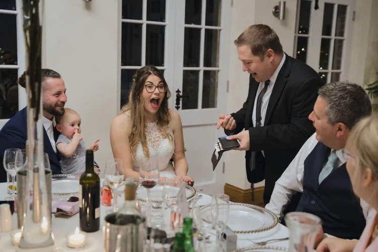 A joyful bride and groom sharing laughter during their wedding reception in Bath.