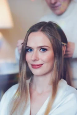 A woman getting her hair done in a salon, captured by an Orchardleigh House wedding photographer.