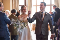A bride and groom walking down the aisle at an Orchardleigh wedding.