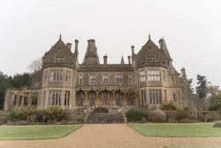 Orchardleigh House, a large mansion in the middle of a grassy field, offers an exquisite backdrop for unforgettable wedding photography.