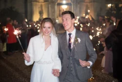 A beautiful bride and groom capturing the magic of their wedding with sparklers, creating stunning Orchardleigh House photos.