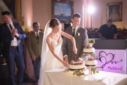 A beautiful bride and groom cutting their wedding cake at Orchardleigh House, captured in stunning photos.
