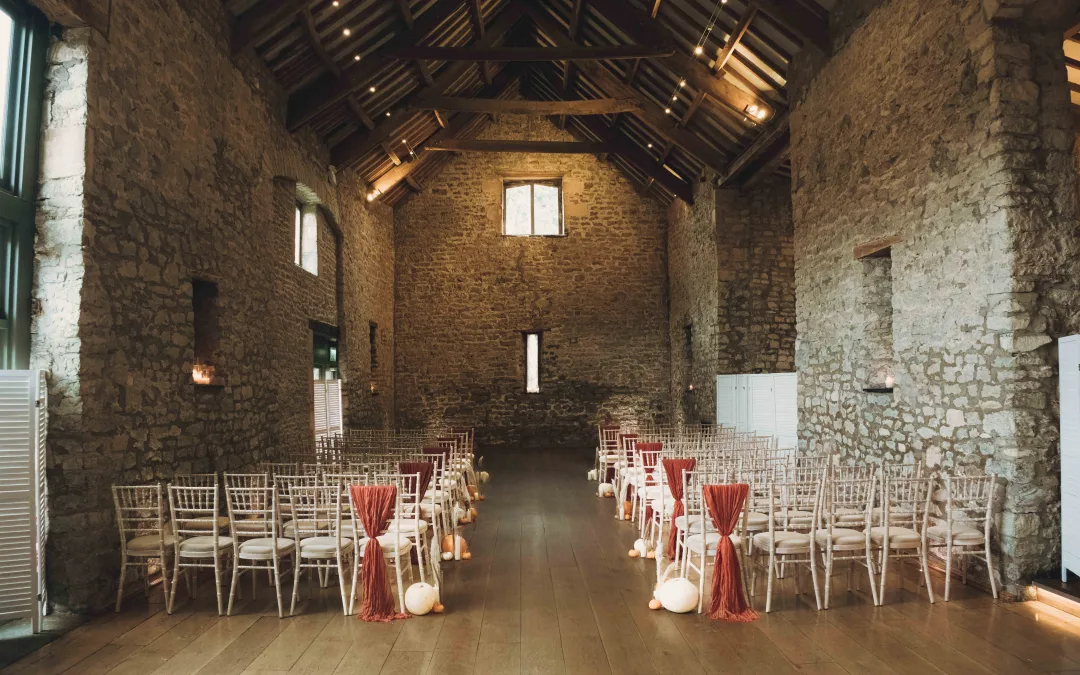 A wedding ceremony set up in a stone building.Priston Mill Wedding Photographer
