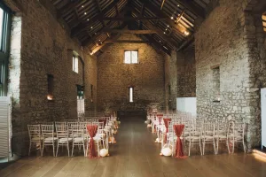 A wedding ceremony set up in a stone building.Priston Mill Wedding Photographer