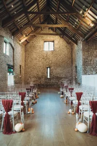 A wedding ceremony set up in a stone barn. Priston Mill Wedding Photographer