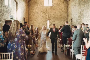 A bride and groom walking down the aisle at their wedding.Priston Mill Wedding Photographer