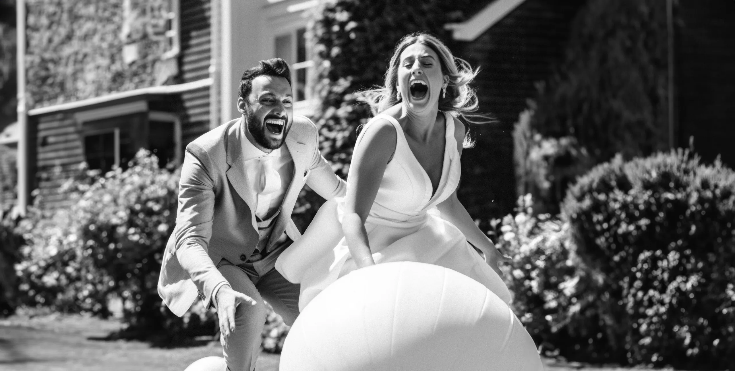 A bride and groom playing with a large white ball. The new way to shoot your wedding